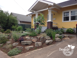 Boulders and attractive plants replace steeply sloped lawn in Foster Powell front yard