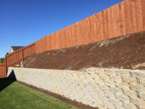 Their lot was challenging with the hardscape wall.