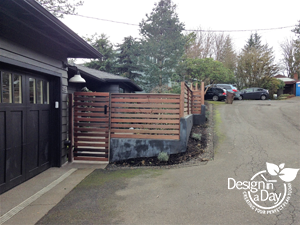 Modern style fencing creates courtyard style landscape design for West Hills home in Portland Oregon . Dyed concrete walls and wood fence