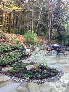 Hardscape Landscape Design for Portland hilllside home includes stone patio and boulders
