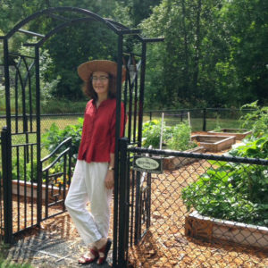 Carol standing at the entrance to community garden at Rocky Pointe Marina 7 23 2014